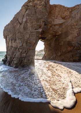 Sea Arch and Foamy Waves