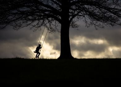 Silhouette of Child on Swing