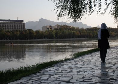 Woman Walking by a Lake