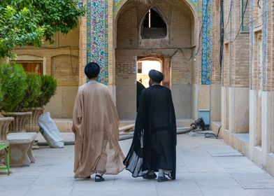 Two Men Walking in Courtyard