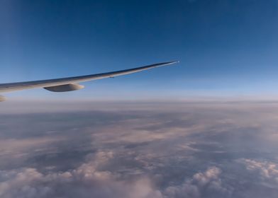 Airplane Wing Above Clouds