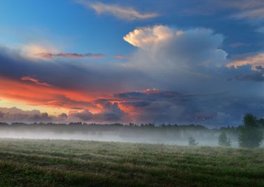 Sunset Over A Misty Field