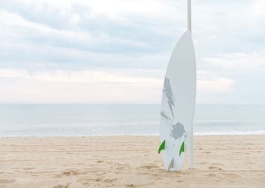 Surf Board In The Sand At