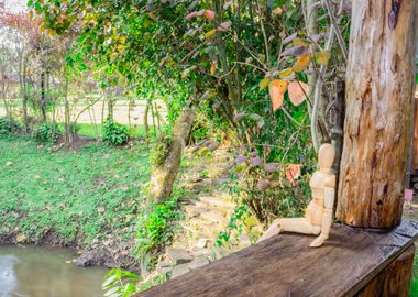 Wooden manikin sitting